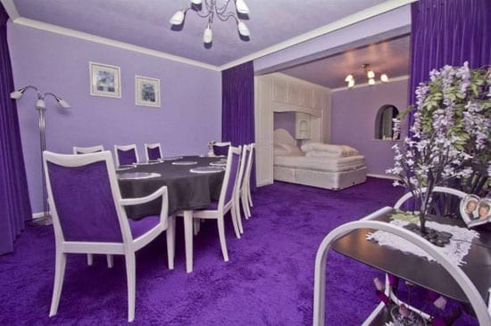 A bizarre dining room cum bedroom is primarily purple also