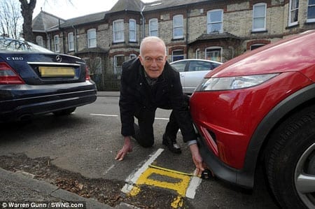 Councillor Damien Tunnacliffe with Britain's shortest double yellow lines in Humberstone Road, West Chesterton, Cambridge