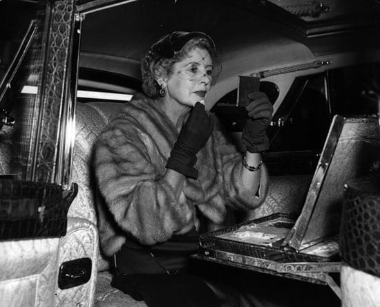 Lady Docker puts on her makeup inside a Docker Daimler in Mayfair in 1954