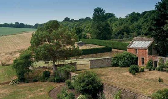 The grounds incorporate lawned gardens and a tennis court