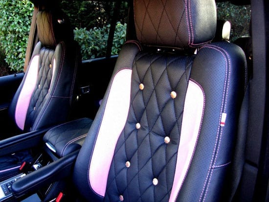 The interior of the vehicle features pink stitching