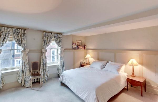The master bedroom is decorated in a simple style and is a blank canvas for a politician of any persuasion