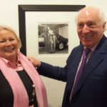 Apothecary-to-The-Prince-of-Wales-John-Webb-stands-with-his-wife-in-front-of-a-Stoddart-photograph-shot-in-the-basement-of-Londons-Blubebird-Garage-1