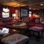 The-main-salon-features-dark-Honduran-mahogany-paneling-and-opulent-fabrics