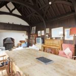The-vaulted-drawing-room-is-dominated-by-a-large-fireplace-1