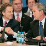 US PRESIDENT BUSH SHAKES HANDS WITH BRITISH PRIME MINISTER BLAIR DURING NATO WORKING SESSION