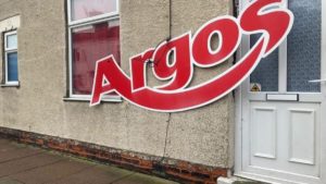 Hero of the Hour – Andy from Argos – Argos sign on Grimsby house – Grimsby resident takes with good humour someone attaching an Argos sign to his house whilst journalist reporting story of it goes all Miss Marple. Facebook group Angry People in Local Newspapers, GrimsbyLive.