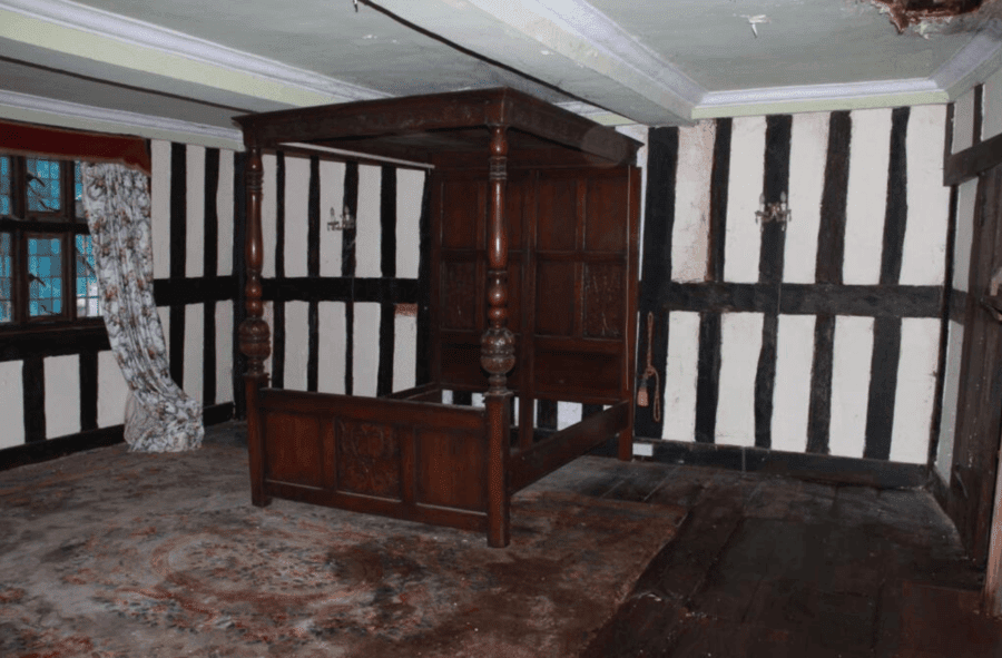 A bedroom with a four poster bed is illustrative of the charm that remained in the house until the death of Miss Sherwood.