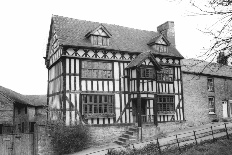 Bromyard is a town described by ‘Britain Express’ as “attractive” and dating to the 9th century. It “boasts a wonderful collection of historic buildings, many of them timber-framed” and “suffered during the Civil War when Prince Rupert, leading the Royalist army, pillaged Bromyard and Ledbury and ‘plundered every parish and house.’” Of The Tower House – pictured here in 1965 – they note: “Another picturesque ‘black and white’ building. King Charles I is said to have stayed at Tower Hill House in March 1645 on his way to Hereford. The house would have been quite modern at the time; it was built in 1630, a date that appears on a pendant under the gable. The house features beautiful decorative panelling around the gable and on moulded barge boards under the eaves.”